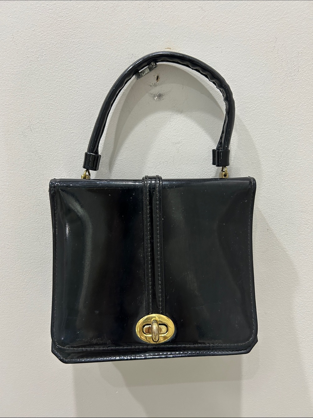 Vintage mid-century Granada USA black patent leather handbag with gold clasp.